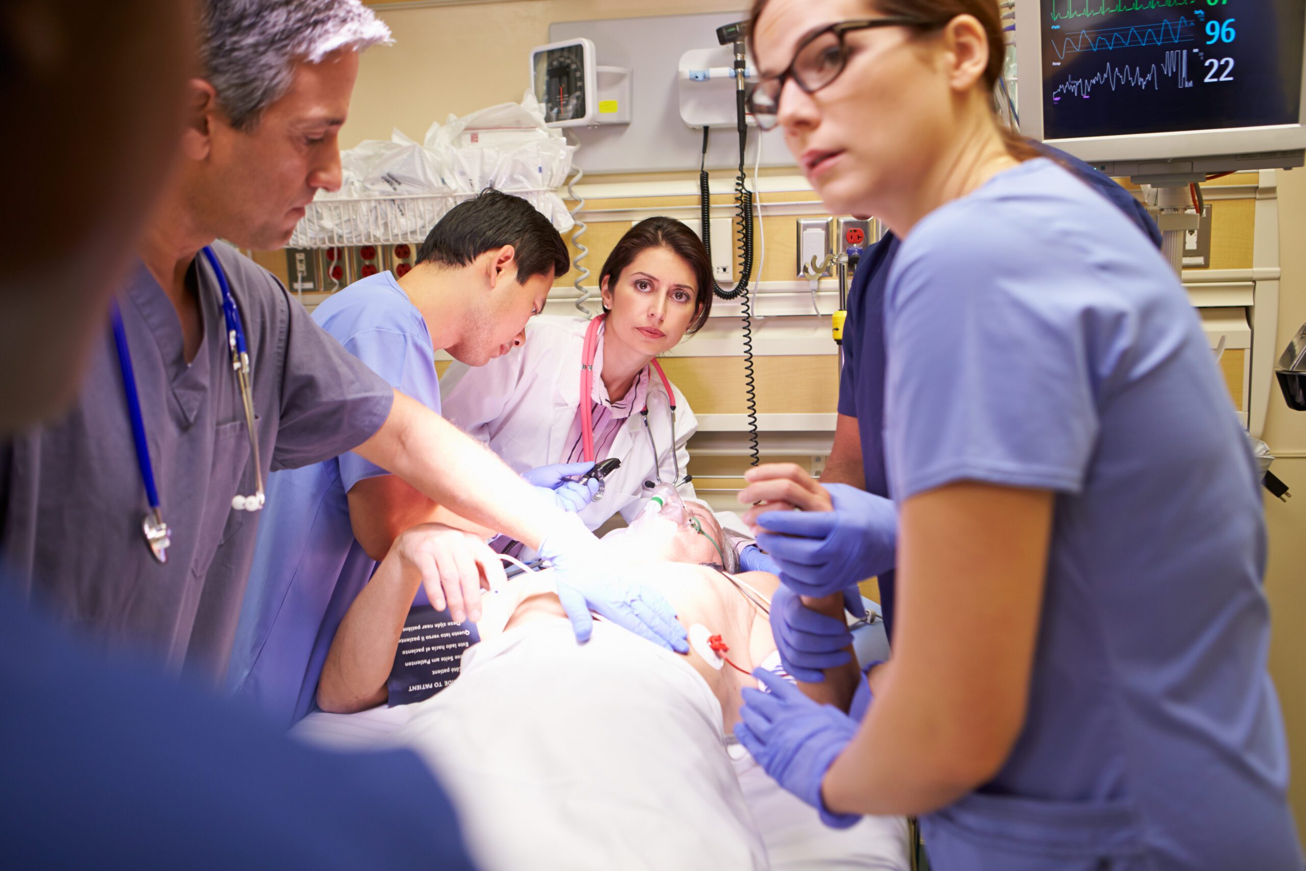 Doctors and emergency personnel working on a patient; As it stands today, the Good Samaritan Act also provides “immunity” to health care providers when they are providing “emergency services” at a medical facility.