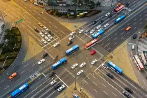 Birds eye view of cars and other vehicles going through a busy intersection