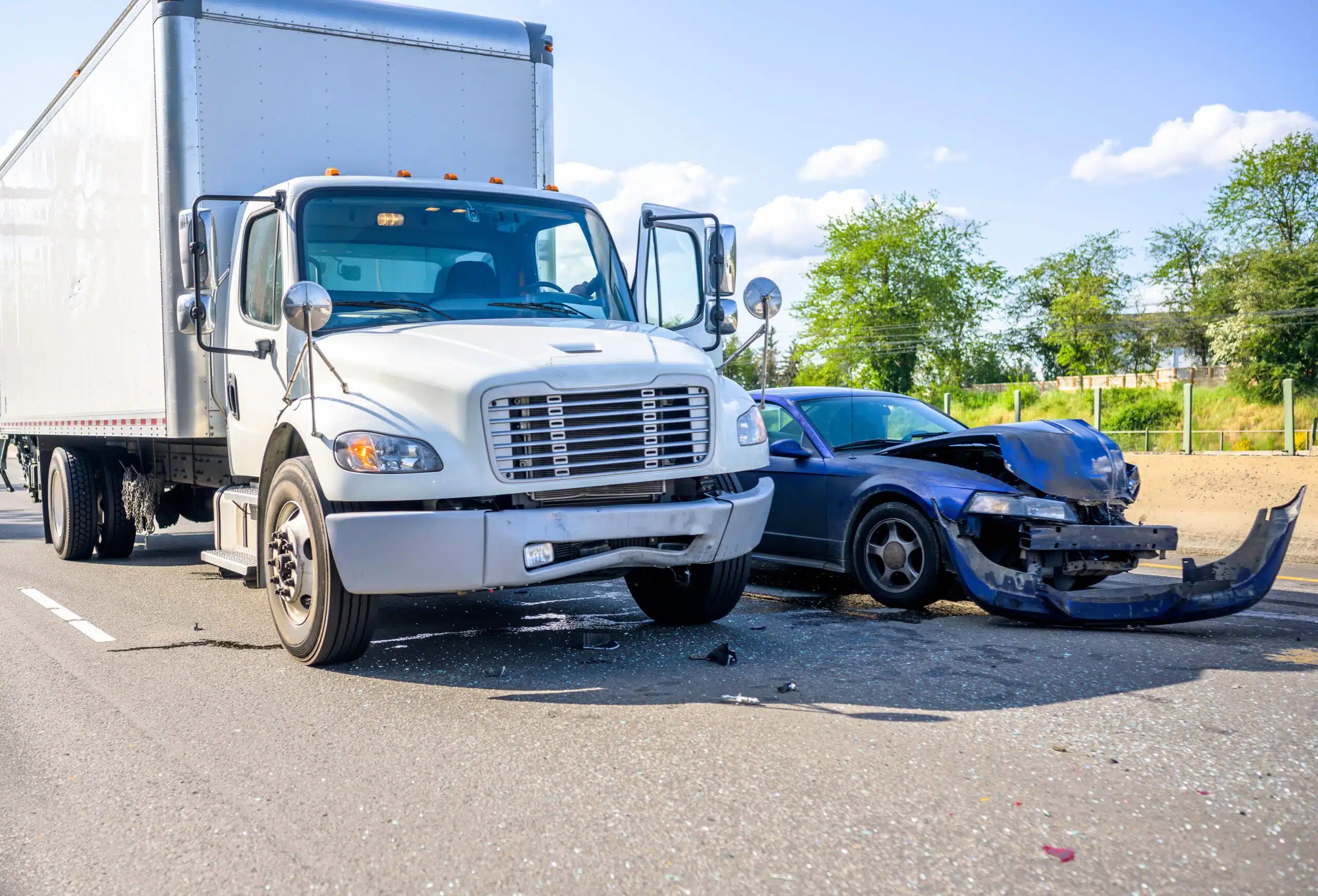 large truck and smashed car after a serious head-on accident